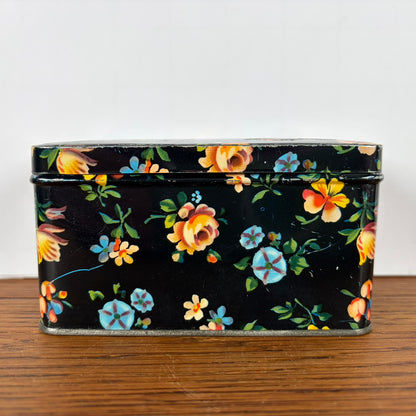 Vintage zwart blikje met bloemetjes