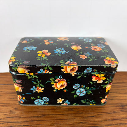 Vintage zwart blikje met bloemetjes