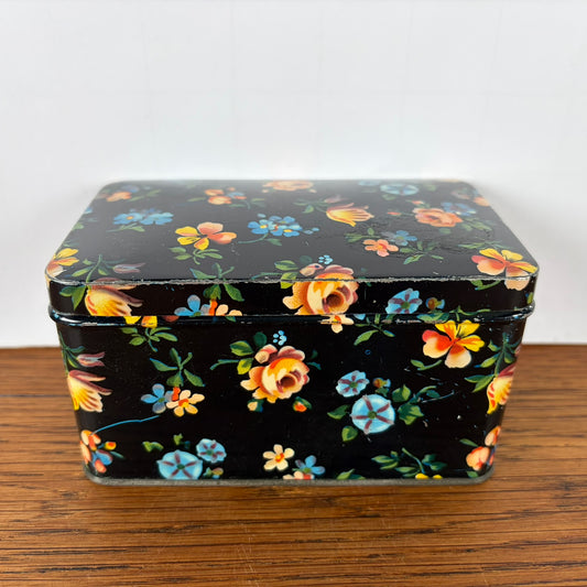 Vintage zwart blikje met bloemetjes