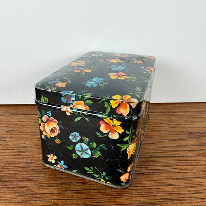 Vintage zwart blikje met bloemetjes