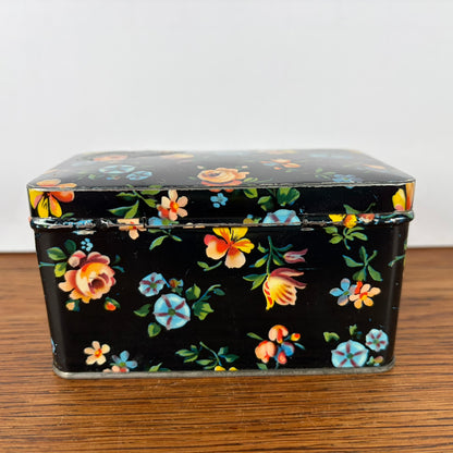Vintage zwart blikje met bloemetjes
