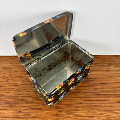 Vintage zwart blikje met bloemetjes