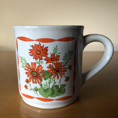 Vintage mok met oranje wilde bloemen